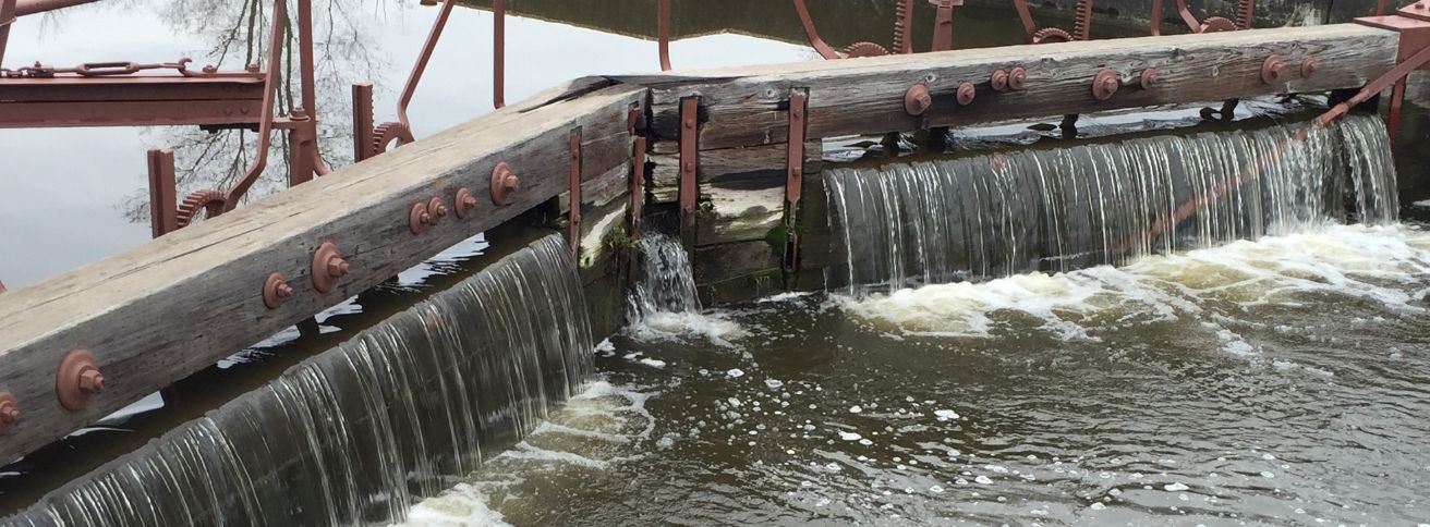 Water spilling over a barrier
